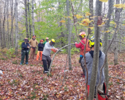 A member attempts to release the tension forces acting in a mock spring pole.